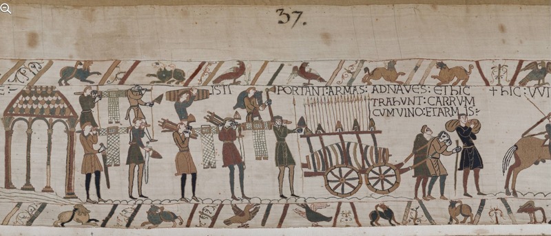 A screenshot of panel 37 of the Bayeux Tapestry. Many figures prepare for war, carrying weapons and armour.