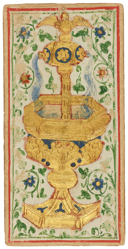 an ornate golden cup shaped like a fountain stands in front of a white and green vines background 