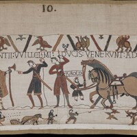 A screenshot of panel 10 of the Bayeux Tapestry. Figures with dane axes converse near horses.