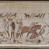 A screenshot of panel 57 of the Bayeux Tapestry. As the battle begins to die down, multiple figures are depicted dead or dying. With few horses remaining, the last of the fighting occurs largely on foot, with axes and spears.