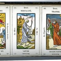 three decorative cards, one with a group of people, another with a skeleton, and a lone person, on top of a horizontal white page